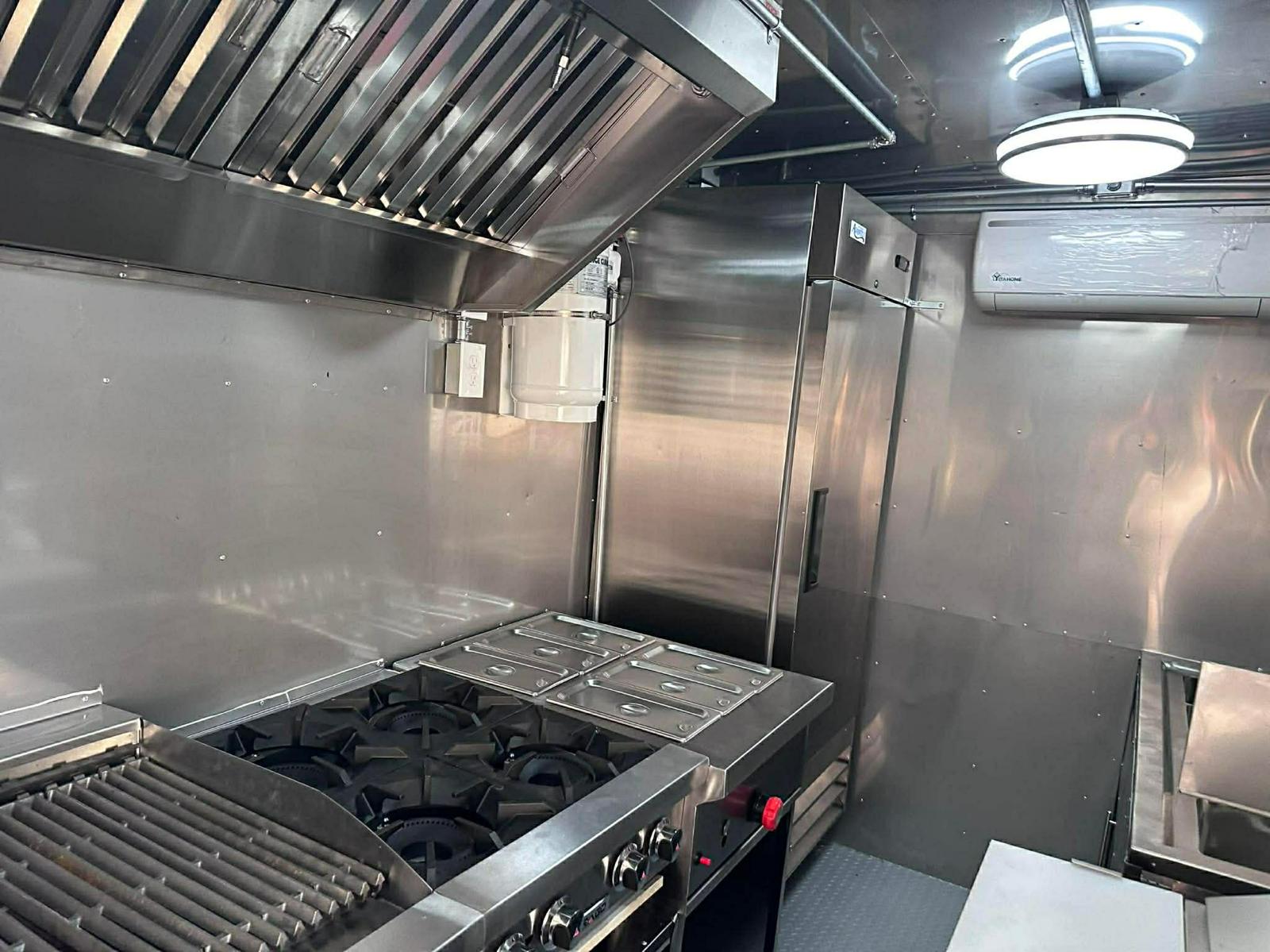 Stainless steel commercial kitchen inside a food trailer